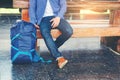 Traveler man waits train on railway platform