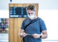 Traveler with mask stuck in airport no able to return home country due to COVID-19 border closures Royalty Free Stock Photo