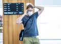 Traveler with mask stuck in airport no able to return home country due to COVID-19 border closures Royalty Free Stock Photo