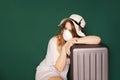 Traveler with a medical mask on face is waiting for flight due to a coronavirus Royalty Free Stock Photo