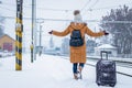 Woman with luggage is looking at leaving train