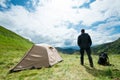 Traveler in the mountains near the tent Royalty Free Stock Photo