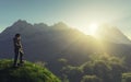 Traveler standing on a cliff looking at mountains during sunset