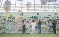 The traveler are painting on the long white wall in Chiang Rai ASEAN Flower Festival 2020