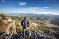 Traveler on peak of mountain. Royalty Free Stock Photo