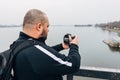 Traveler photographer on bridge is taking picture