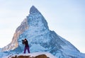 Photographer woman taking pictures of Swiss Alps against Matterhorn peak Royalty Free Stock Photo