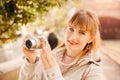 Traveler and photographer. Young woman smiles and makes lifestyle photo travel