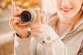 Traveler and photographer. Young woman smiles and makes lifestyle photo travel