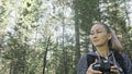 Traveler photographing scenic view in forest. One caucasian woman shooting nice magic look. Girl take photo video on Royalty Free Stock Photo