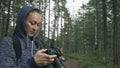 Traveler photographing scenic view in forest. One caucasian woman shooting nice magic look. Girl take photo video on