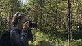 Traveler photographing scenic view in forest. One caucasian woman shooting nice magic look. Girl take photo video on