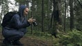 Traveler photographing scenic view in forest. One caucasian woman shooting nice magic look. Girl take photo video on