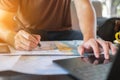 Traveler is planning vacation using the world map. Man is writing notes and pointing on the map while the man is discussing Royalty Free Stock Photo