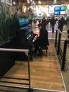 Traveler plays public piano in Paris train station Royalty Free Stock Photo