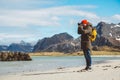 Traveler is a professional photographer taking over the landscape photo landscape. Wearing a yellow backpack in a red