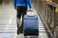 Traveler pulling suitcase close-up Royalty Free Stock Photo