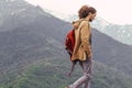 Traveler with red backpack walking on mountain. Travel Lifestyle adventure vacations freedom concept Royalty Free Stock Photo