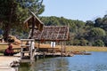 Traveler relaxing on bamboo bridge and hut in lake