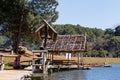 Traveler relaxing on bamboo bridge and hut in lake