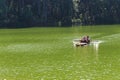 Traveler relaxing on bamboo raft in brigt lake