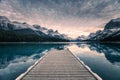 Traveler relaxing on wooden pier in Maligne lake at Spirit island, Jasper national park Royalty Free Stock Photo