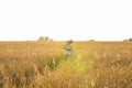 Traveler, romantic travel background, young man leaving home, guy with guitar walking at sunset field Royalty Free Stock Photo