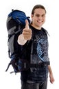 Traveler with rucksack and thumbs up