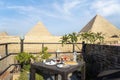 Traveler\'s breakfast. A table in an outdoor restaurant with a fantastically beautiful view of the great pyramids of Giza. Cairo.