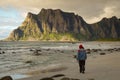 Traveler on a scenic beach on the Lofoten islands