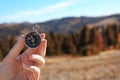 Traveler searching direction with compass in wilderness Royalty Free Stock Photo