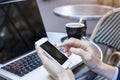 Traveler sending emails with laptop and smartphone during coffee break outdoor