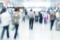 Commuters in motion blur, airport interior Royalty Free Stock Photo