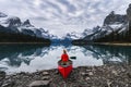 Traveler sitting with paddle on canoe in Maligne lake at Spirit Island Royalty Free Stock Photo