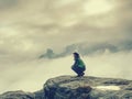 Traveler sitting on the sandstone cliff. Rear view of male hiker Royalty Free Stock Photo