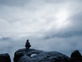 Traveler sitting on the sandstone cliff. Rear view of male hiker Royalty Free Stock Photo