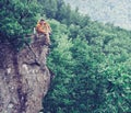 Traveler sitting on top of cliff