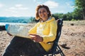 Traveler smile girl looking on map vacation trip, woman planning trip, hipster tourist on background nature, enjoy lifestyle holid Royalty Free Stock Photo