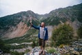 Traveler stand alone, take a picture, selfie on his smarphone Caucasus mountains Ushba on background, Svaneti, Georgia. Summer