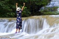 Traveler stand enjoy in waterfall at Erawan Waterfall and natural