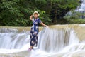 Traveler stand relax in waterfall at Erawan Waterfall and natura