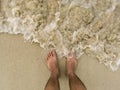 The traveler stand on the sand beach with sea wave