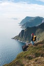 Traveler standing on the edge cliff rock above sea and enjoying epic view Royalty Free Stock Photo