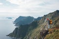 Traveler standing on the edge cliff rock above sea and enjoying epic view Royalty Free Stock Photo