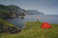 Traveler Standing and Hands Raising on the Cliff and Looking at the Pacific Ocean Coastline on Shikotan Island, Lesser Kuril Chain