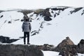 Traveler standing on the rock on the mountain in winter