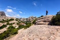 Traveler is staying among Montserrat rocks near the Montserrat abbey, Catalonia, Spain