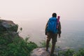 Traveler successful young man standing on top of Mountain and wa Royalty Free Stock Photo