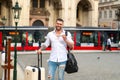 Traveler with suitcase. Business man on business trip walking with travel bag on city street. Travelling businessman. Royalty Free Stock Photo