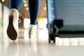 Traveler with suitcase walking with carrying luggage and passenger for tour in the airport terminal for air traveling Royalty Free Stock Photo